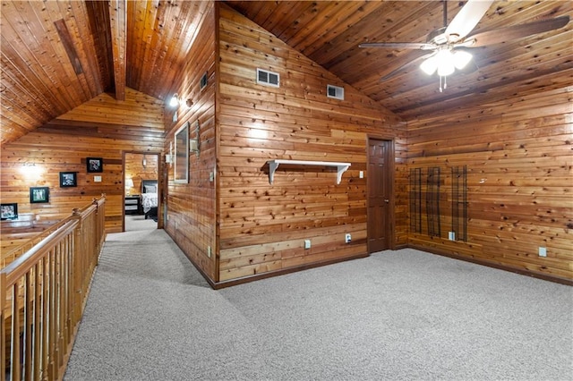 hall with light carpet, wooden walls, and wooden ceiling