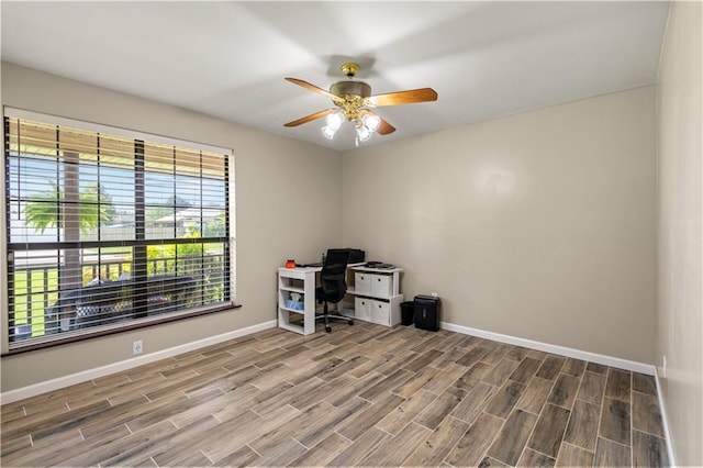 unfurnished office featuring ceiling fan and hardwood / wood-style floors