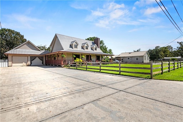 country-style home with a garage, a front lawn, and covered porch