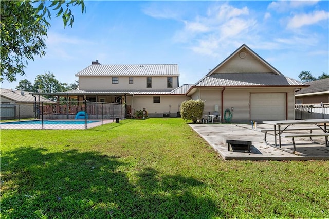 back of house with a lawn, a fenced in pool, and a patio area