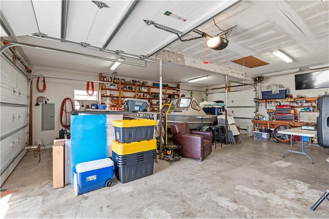 garage featuring a garage door opener, a workshop area, and electric panel