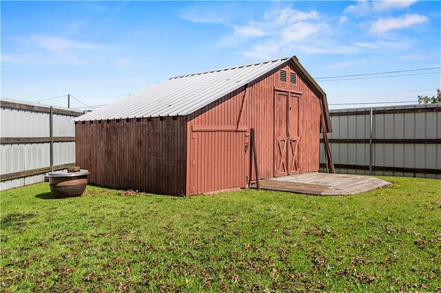 view of outbuilding with a yard