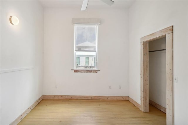 unfurnished bedroom featuring light wood-type flooring and ceiling fan