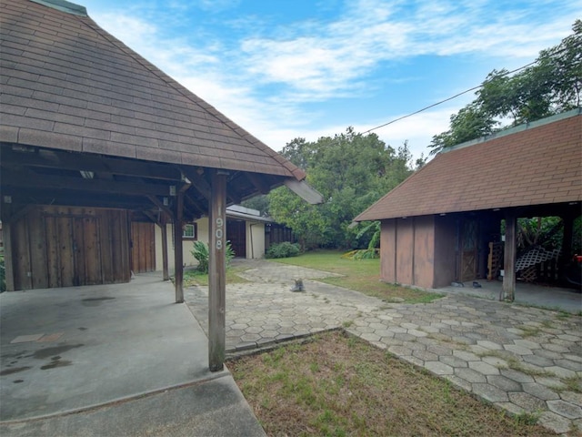 view of yard with a carport and an outdoor structure