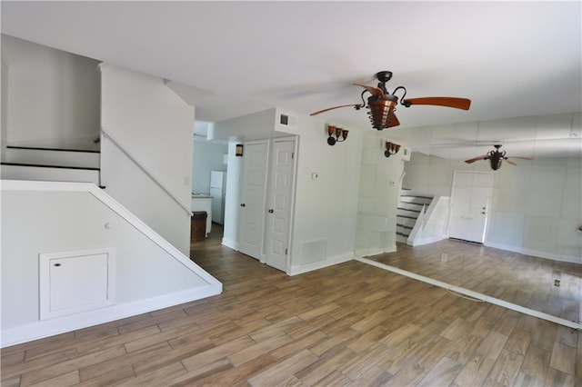 interior space with ceiling fan and hardwood / wood-style floors