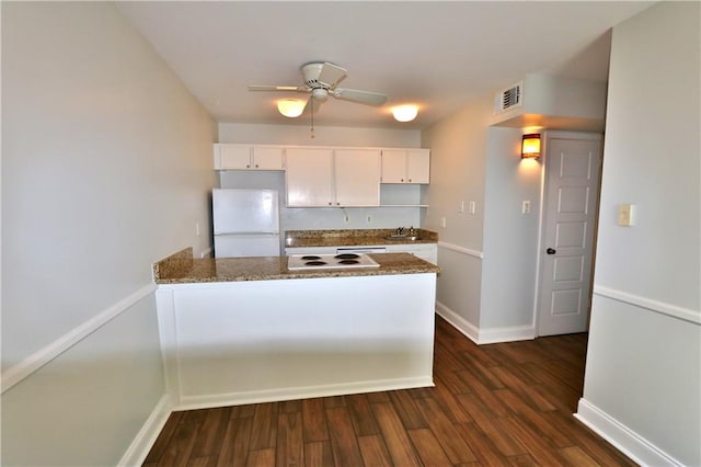 kitchen featuring white cabinetry, ceiling fan, white fridge, and dark hardwood / wood-style flooring