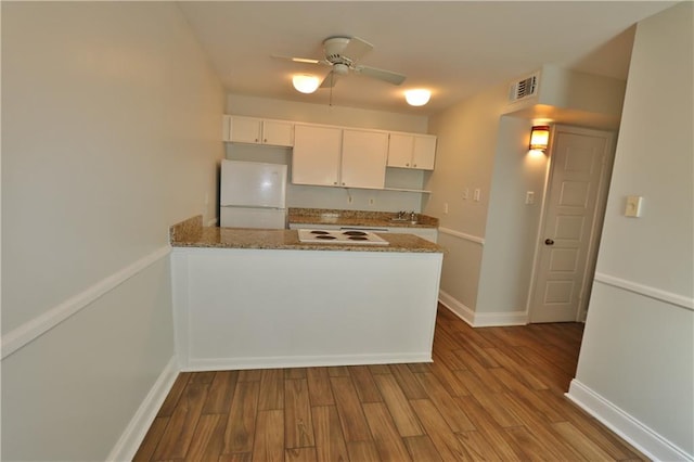 kitchen featuring ceiling fan, light hardwood / wood-style flooring, white appliances, and white cabinetry