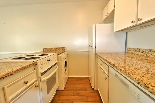 kitchen featuring white cabinetry, light stone counters, white appliances, washer / dryer, and hardwood / wood-style flooring