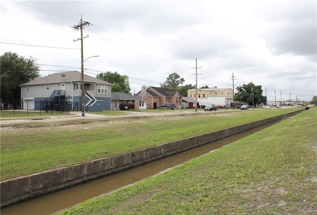 view of home's community with a yard