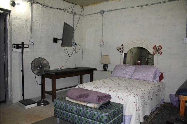 bedroom featuring concrete flooring