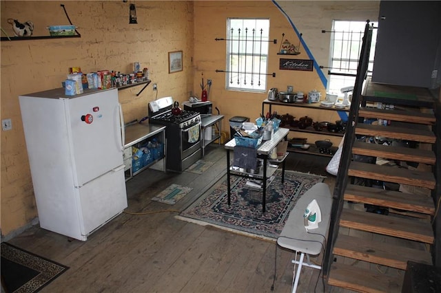 basement with white refrigerator and dark wood-type flooring