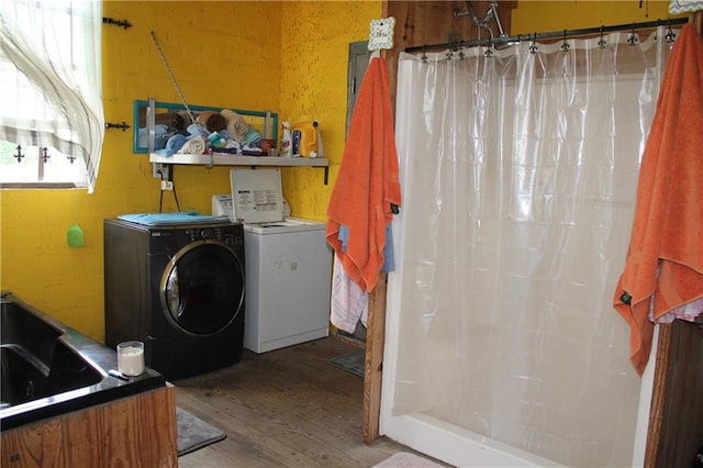 laundry area featuring independent washer and dryer and hardwood / wood-style flooring