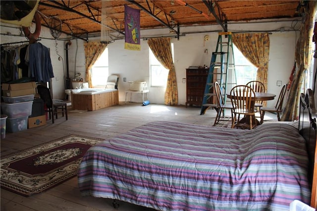 bedroom featuring wood-type flooring and multiple windows