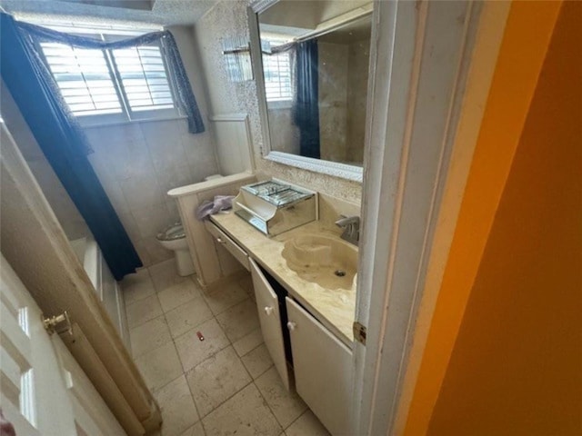 bathroom featuring vanity, tile patterned floors, and toilet