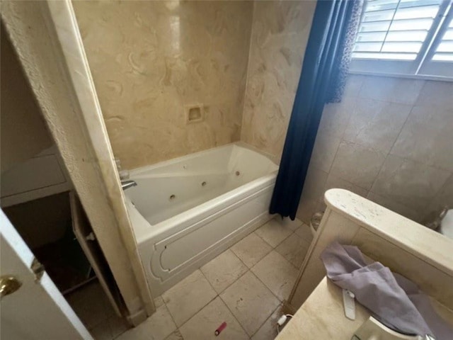 bathroom with shower / bath combination with curtain and tile patterned floors