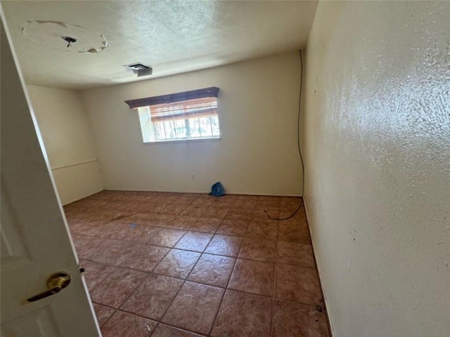 empty room with a textured ceiling