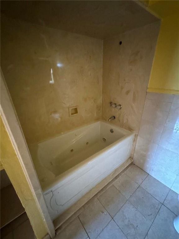 bathroom featuring a tub to relax in and tile patterned flooring