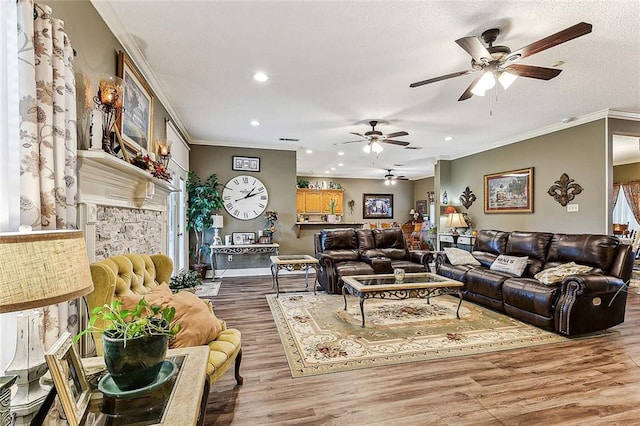 living room featuring hardwood / wood-style flooring, a textured ceiling, and crown molding