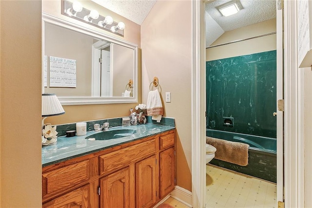 full bathroom with shower / bath combination, a textured ceiling, toilet, and vanity