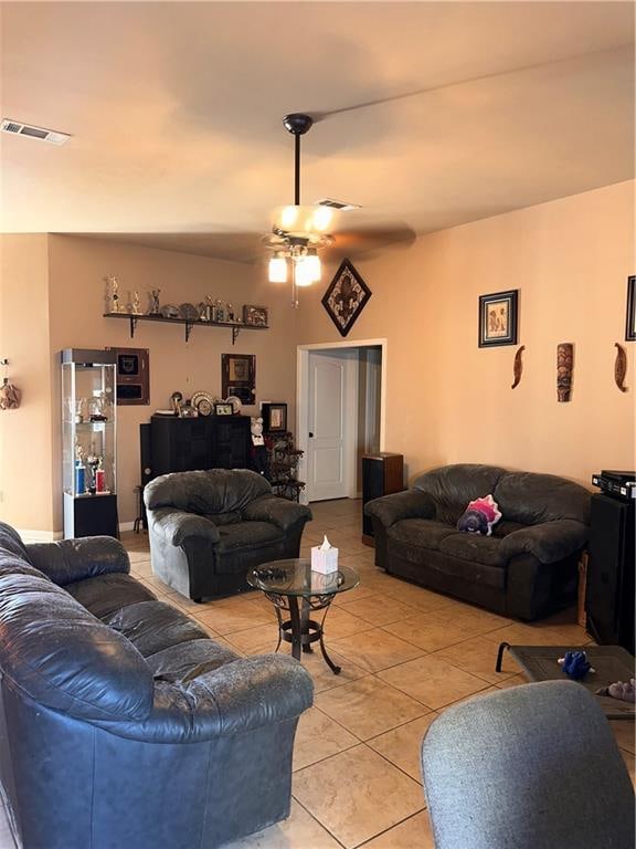 living room featuring light tile patterned floors and ceiling fan