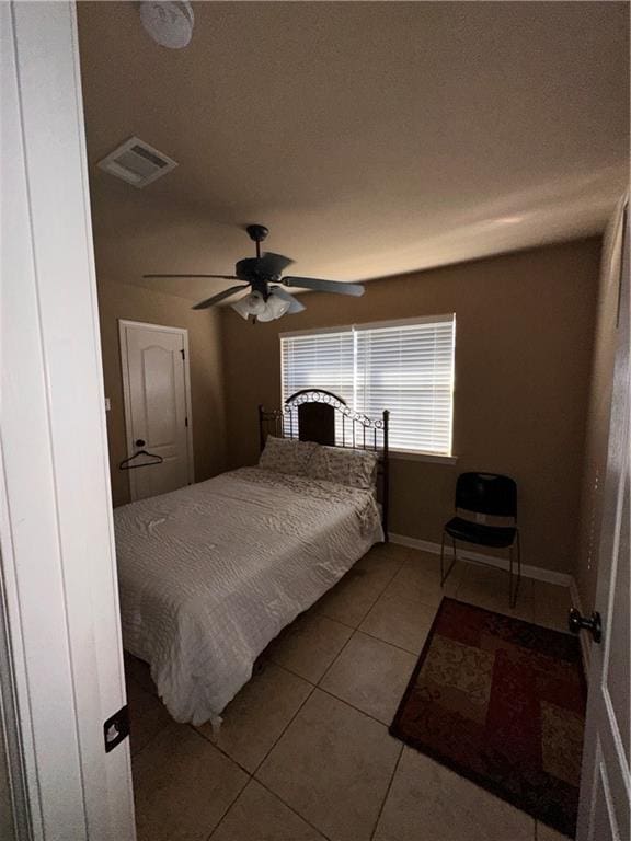 bedroom featuring ceiling fan and tile patterned floors