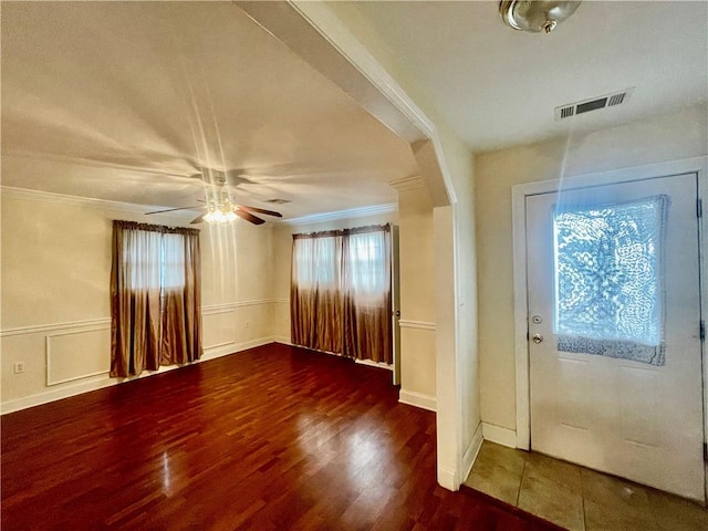 foyer featuring ceiling fan, crown molding, and dark hardwood / wood-style flooring