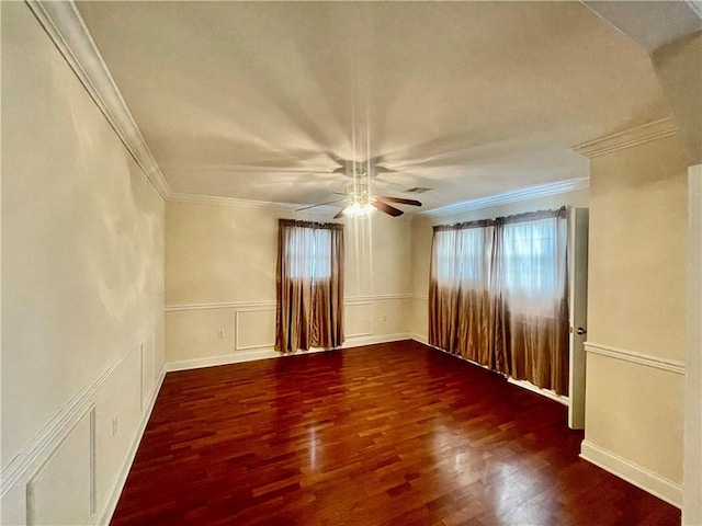 empty room with ornamental molding, ceiling fan, and dark hardwood / wood-style floors