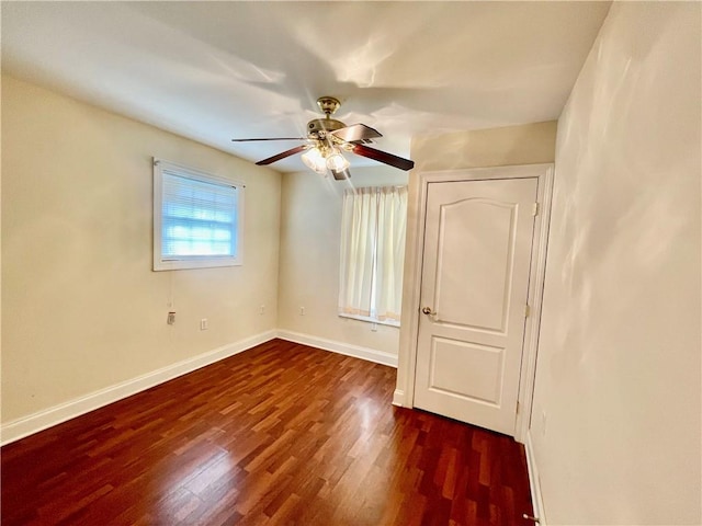 unfurnished bedroom with ceiling fan and dark hardwood / wood-style floors