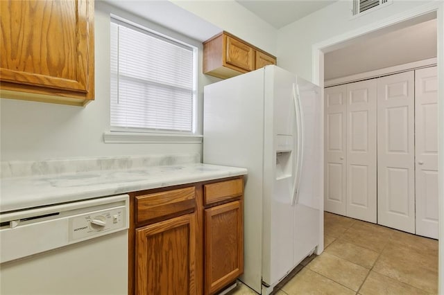 kitchen with light tile patterned floors and white appliances