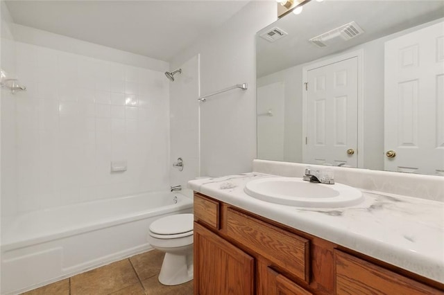 full bathroom with tile patterned flooring, vanity, toilet, and tiled shower / bath