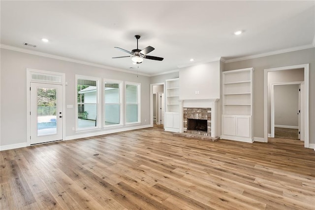 unfurnished living room featuring light wood-type flooring, crown molding, a fireplace, and ceiling fan