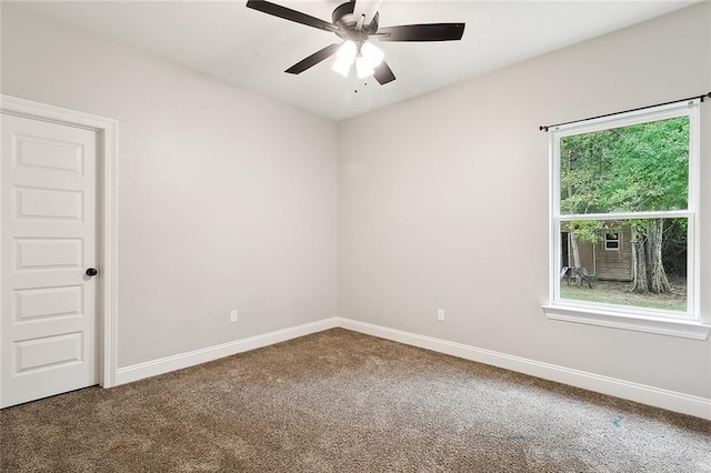 carpeted spare room with ceiling fan