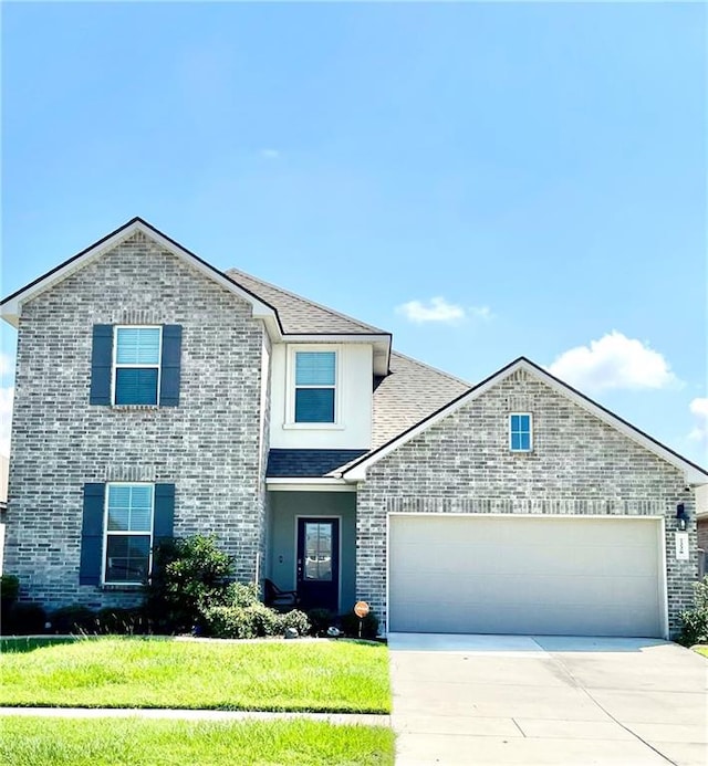 view of property with a front yard and a garage