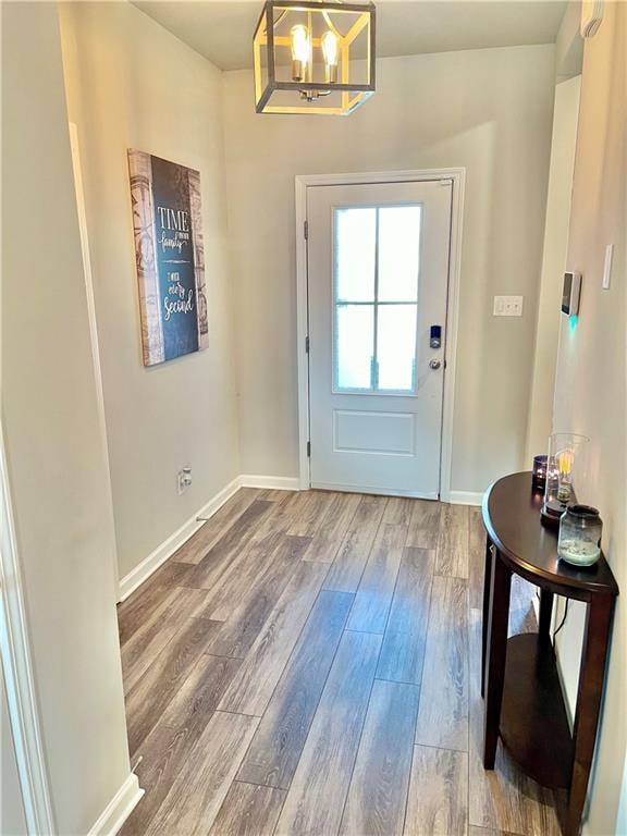 entryway with hardwood / wood-style flooring and an inviting chandelier