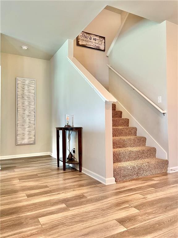 staircase with hardwood / wood-style flooring