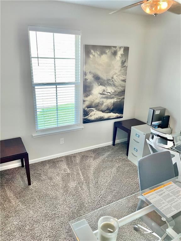 carpeted home office with plenty of natural light and ceiling fan