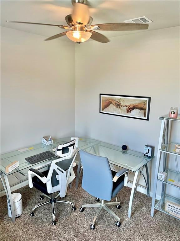 carpeted office featuring ceiling fan