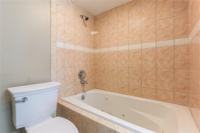 bathroom with toilet and tiled shower / bath