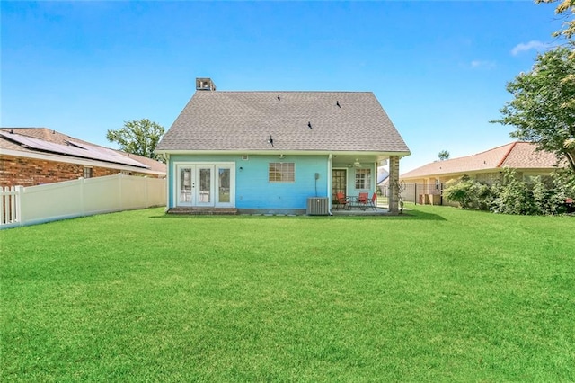 back of house featuring a patio, a lawn, and french doors