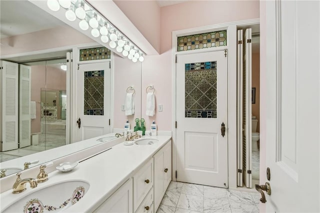 bathroom featuring vanity and toilet