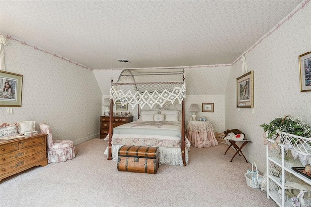 carpeted bedroom with a textured ceiling, lofted ceiling, and crown molding