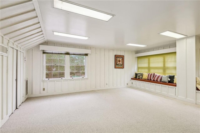 interior space featuring lofted ceiling and light colored carpet