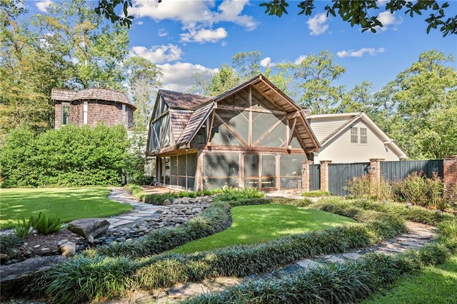 rear view of property with a lawn