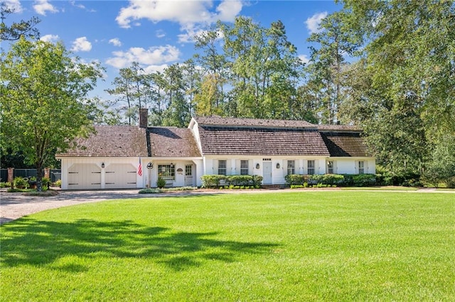 view of front of house featuring a garage and a front lawn