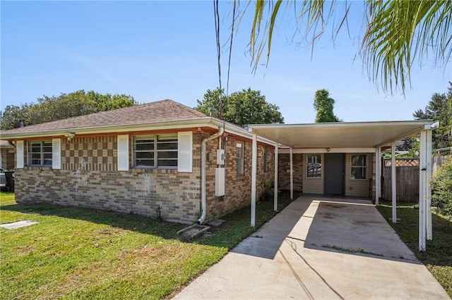 view of front facade featuring a front yard and a carport