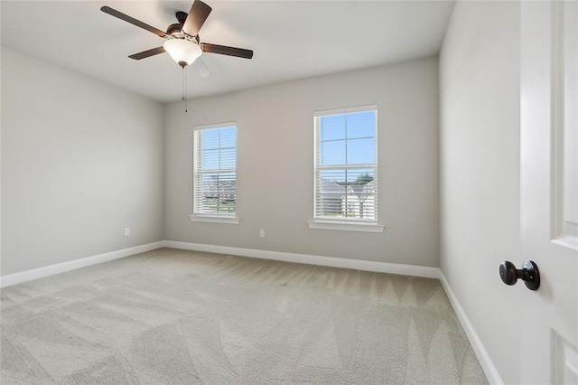 carpeted spare room with ceiling fan and a healthy amount of sunlight