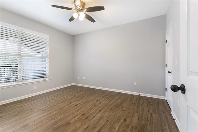 empty room with ceiling fan and dark wood-type flooring