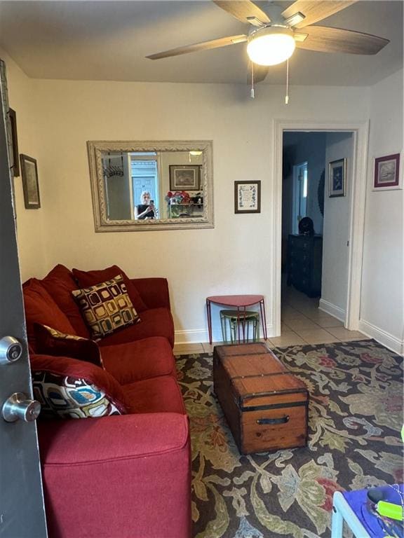 tiled living room with ceiling fan