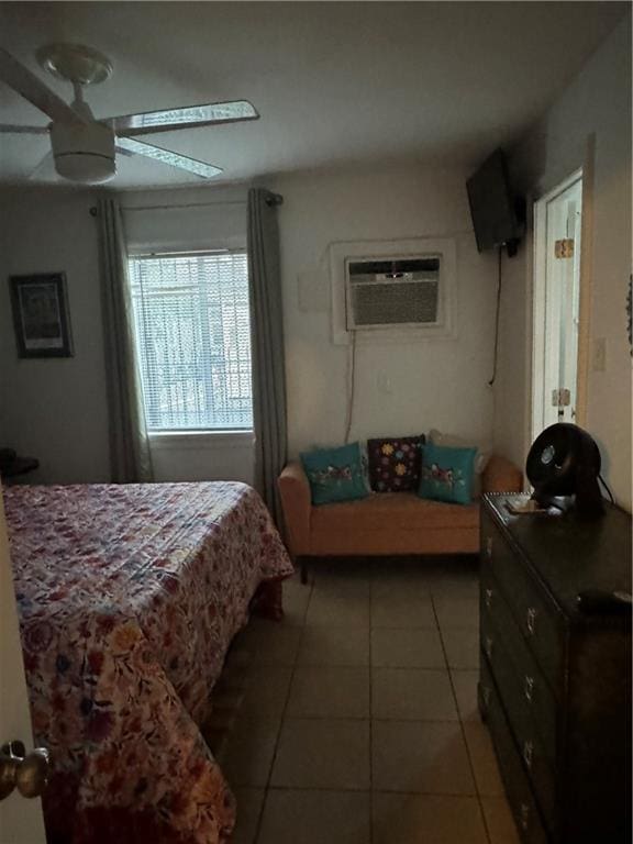 bedroom with ceiling fan, a wall unit AC, and tile patterned floors