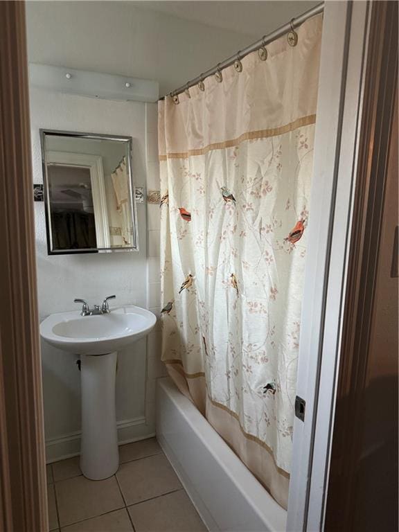 bathroom with shower / bath combination with curtain and tile patterned floors